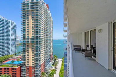 a balcony of a building with a view of the ocean at Relaxing 1-Bed Condo With City Views in Brickell Key in Miami
