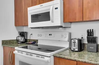 a white stove top oven with a microwave above it at Elegant 1 BR Retreat in Brickell With Free Parking in Miami