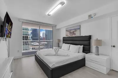 a bedroom with a large bed with a large window at Elegant 1 BR Retreat in Brickell With Free Parking in Miami