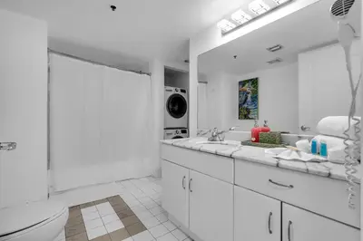 a white bathroom with two sinks and a toilet at Elegant 1 BR Retreat in Brickell With Free Parking in Miami