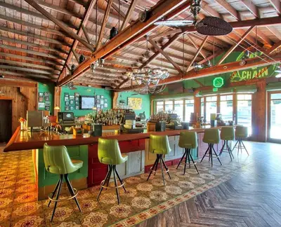 a bar with green bar stools in a restaurant at Apartment in the Heart of Calle 8 with Parking in Miami