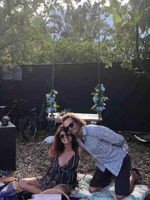 a man and a woman sitting on a blanket at Unique Studio in Little Havana Reserved Parking in Miami