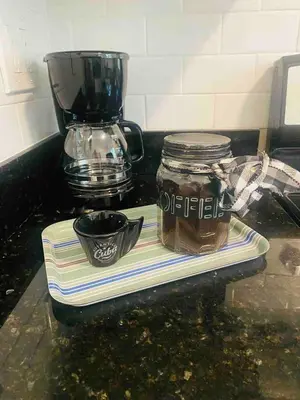 a counter with a blender and a jar of honey at 3 Bedroom Apartment with Backyard Oasis in Miami