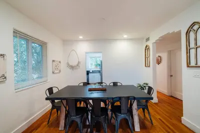 a dining room with a black table and chairs at Families Welcome 3 Bedroom Oasis with Parking in Miami