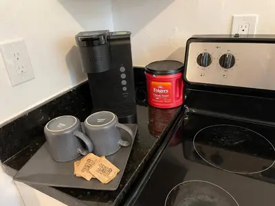 two coffee mugs on a counter next to a stove at Families Welcome 3 Bedroom Oasis with Parking in Miami