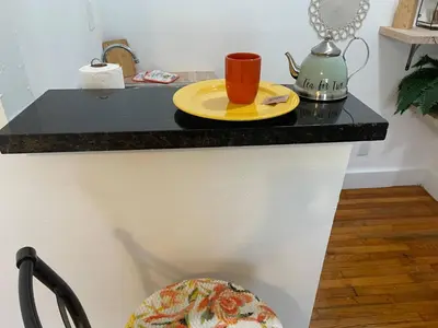 a counter with a yellow plate and a cup on it at Tropical Paradise in Miracle Mile with Parking in Miami