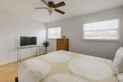 a living room with a table and a flat screen tv at Waterside retreat in Fort Lauderdale