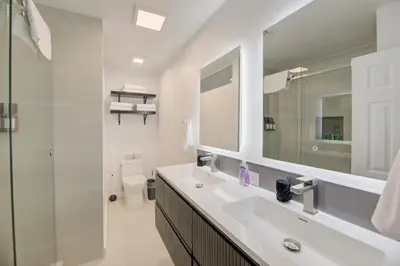 a bathroom with a sink and a toilet and a mirror at Waterside retreat in Fort Lauderdale