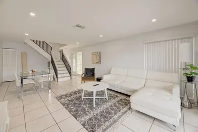 a living room with a white couch and a table at Intracostal Beauty in Fort Lauderdale