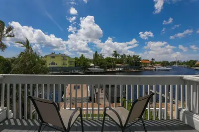 a balcony with chairs and a view of the water at Intracostal Beauty in Fort Lauderdale