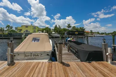 a boat is docked at a dock on the water at Intracostal Beauty in Fort Lauderdale