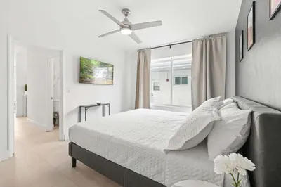 a bedroom with a bed and a ceiling fan at Miami Magic 1BR 4 Guests in Miami Beach