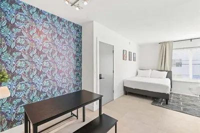 a bedroom with a bed and a table in a room at Miami Magic 1BR 4 Guests in Miami Beach