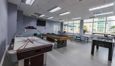 a large room with a ping pong table and a pool table at Brickell 1 Bed 1 Bath Free Parking in Miami