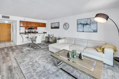 a living room with a white couch and a table at Brickell 1 Bed 1 Bath Free Parking in Miami