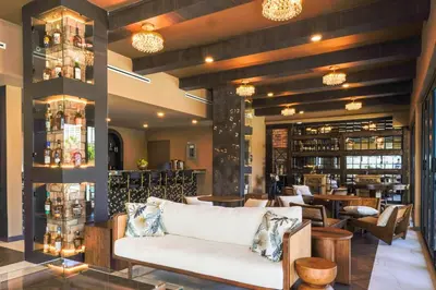 a lobby with a couch and a bar at Barley House Hotel, Trademark Collection by Wyndham in Fort Lauderdale