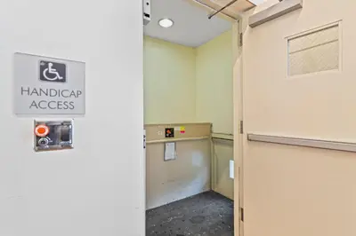 an empty room with a handicap access sign on the wall at Private Residences at Hotel Arya by SoFLA Vacations in Miami