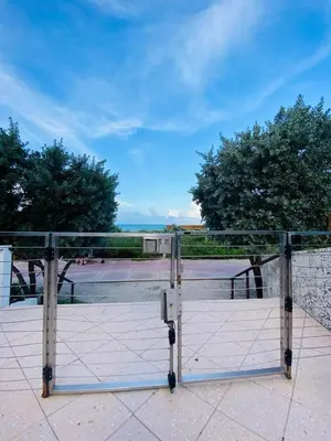 a gate on a balcony with a view of the ocean at Carillon Miami Beach Private Luxury Suites in Miami Beach