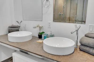 two white sinks on a counter in a bathroom at Sun, Style and Skyline Modern Icon Brickell 2BR in Miami