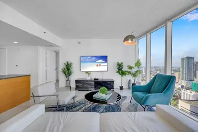 a living room with a view of a city at Sun, Style and Skyline Modern Icon Brickell 2BR in Miami