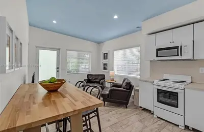 a kitchen and dining room with a table and chairs at Avocado House A Coconut Grove Bungalow in Miami