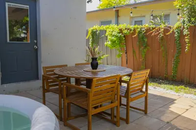 a wooden table with chairs and a vase on it at 10 min to Las Olas and Beach WD 2 Bed in Fort Lauderdale