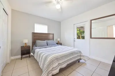 a white bedroom with a bed and a window at 10 min to Las Olas and Beach WD 2 Bed in Fort Lauderdale