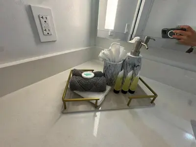 a person taking a picture of a bathroom sink at Luxury Downtown Miami Stay in Upscale Building in Miami