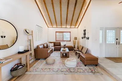 a living room with a couch and a table at Waterfront Villa with Beach, Game Room, Cinema and Spa in Pembroke Pines