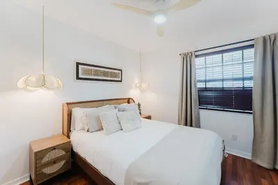 a bedroom with a white bed and a window at Waterfront Villa with Beach, Game Room, Cinema and Spa in Pembroke Pines