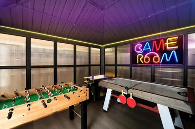 a room with a ping pong table and a game room at Waterfront Villa with Beach, Game Room, Cinema and Spa in Pembroke Pines