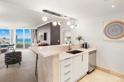 a kitchen with a sink and a living room at Ocean View Private Residence at Fontainebleau -3505 in Miami Beach