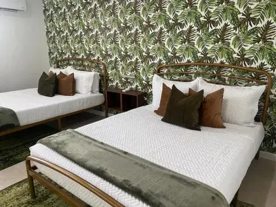 two beds in a room with pillows on them at Tropical Oasis in Pembroke Pines