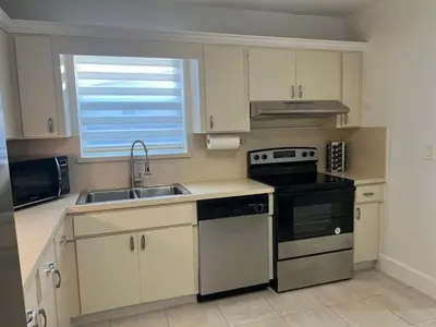a kitchen with a sink and a stove at Tropical Oasis in Pembroke Pines