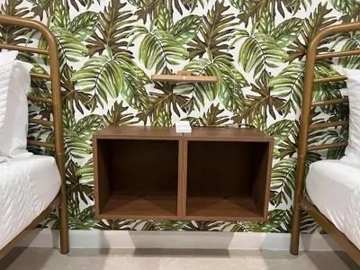 a bedroom with a wooden table and a tropical wallpaper at Tropical Oasis in Pembroke Pines