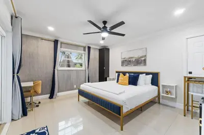 a bedroom with a bed and a ceiling fan at Stylish Bedroom Suite in Pembroke Pines
