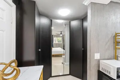 a bathroom with black walls and a glass door at Stylish Bedroom Suite in Pembroke Pines