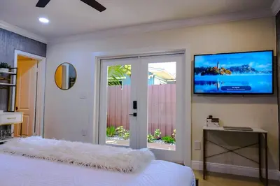 a bedroom with a bed and a flat screen tv at Stylish Bedroom Suite in Pembroke Pines
