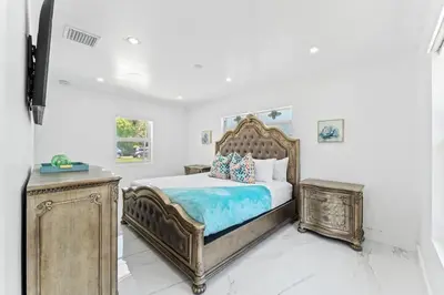 a bedroom with a large bed with a wooden frame at Family Splash Escape in Fort Lauderdale