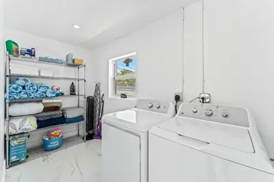 a white kitchen with two sinks and a dishwasher at Family Splash Escape in Fort Lauderdale