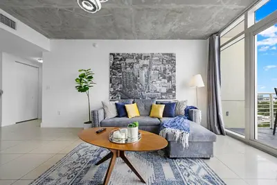 a living room with a couch and a table at Midblock Midtown Miami High Floor 1B Suite W Spa Pool Gym in Miami