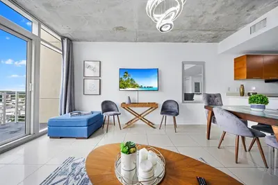 a living room with a table and a dining room at Midblock Midtown Miami High Floor 1B Suite W Spa Pool Gym in Miami