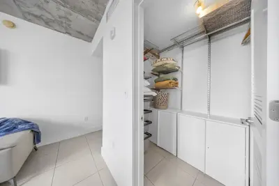 a bathroom with white cabinets and a closet at Midblock Midtown Miami High Floor 1B Suite W Spa Pool Gym in Miami