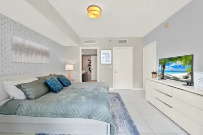a bedroom with a bed and a flat screen tv at Luxurious 5-STAR condo at the ICON Brickell in Miami