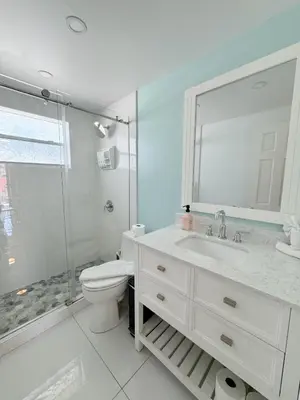 a bathroom with a toilet and a sink and a shower at SeaStays- South Beach Apartments in Miami Beach