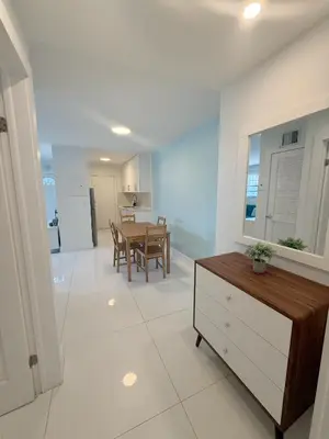 a living room with a table and a dining room at SeaStays- South Beach Apartments in Miami Beach