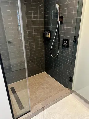 a shower with a glass shower stall with a shower at The Art Studio Downtown in Miami