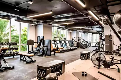 a gym with tread machines and a bike in a room at The Art Studio Downtown in Miami