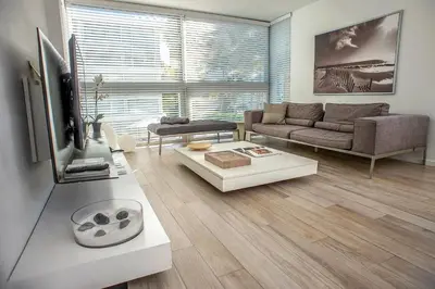 a living room with a couch and a tv at Beach Haus Key Biscayne Contemporary Apartments in Miami