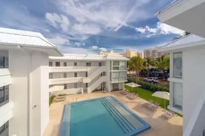 an aerial view of a building with a swimming pool at Beach Haus Key Biscayne Contemporary Apartments in Miami